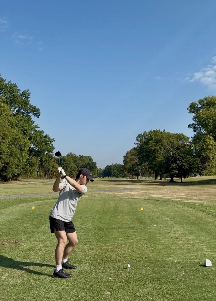 A golf swing on a sunny green course