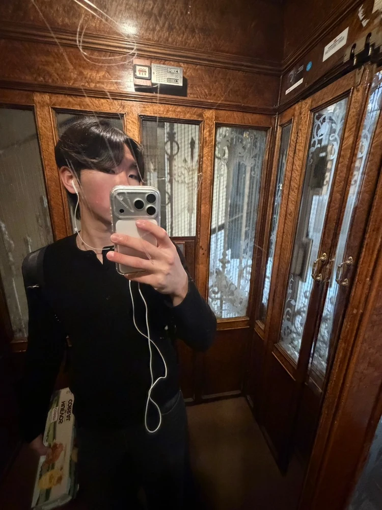 A mirror photo in a wood-paneled elevator